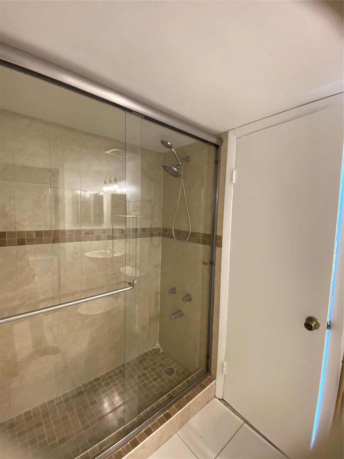 11790 Southwest 18th Street, Unit 106 Miami, FL 33175 - Photo 7 of 23 a bathroom with a glass shower door