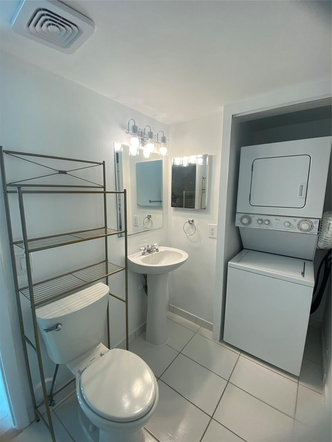 11790 Southwest 18th Street, Unit 106 Miami, FL 33175 - Photo 8 of 23 a bathroom with a toilet sink and mirror