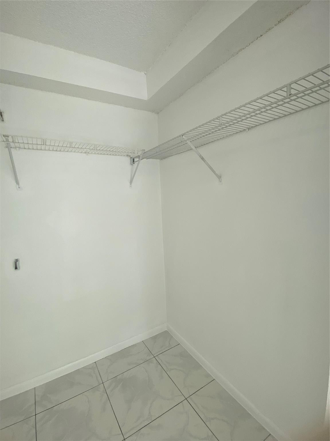 11790 Southwest 18th Street, Unit 106 Miami, FL 33175 - Photo 10 of 23 a view of a room with racks on the wall