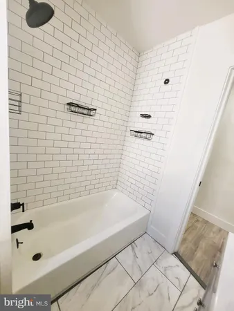 a bathroom with a bathtub and shower