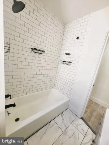 a bathroom with a bathtub and shower