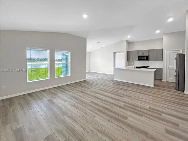 a view of kitchen with wooden floor and window