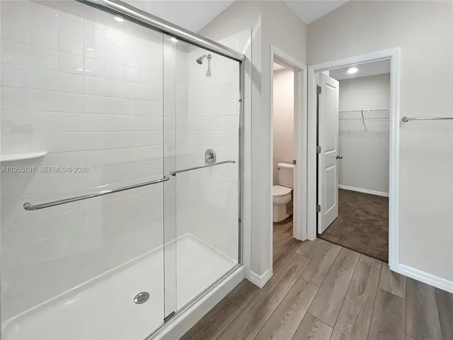 a bathroom with a glass shower door and a bathtub