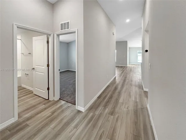 a view of hallway with wooden floor
