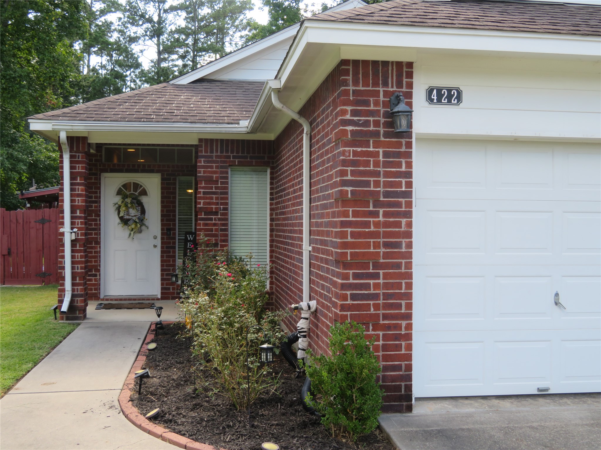 422 East Hunting Tower Run Conroe, TX 77316 - Photo 1 of 20 a front view of a house with garden