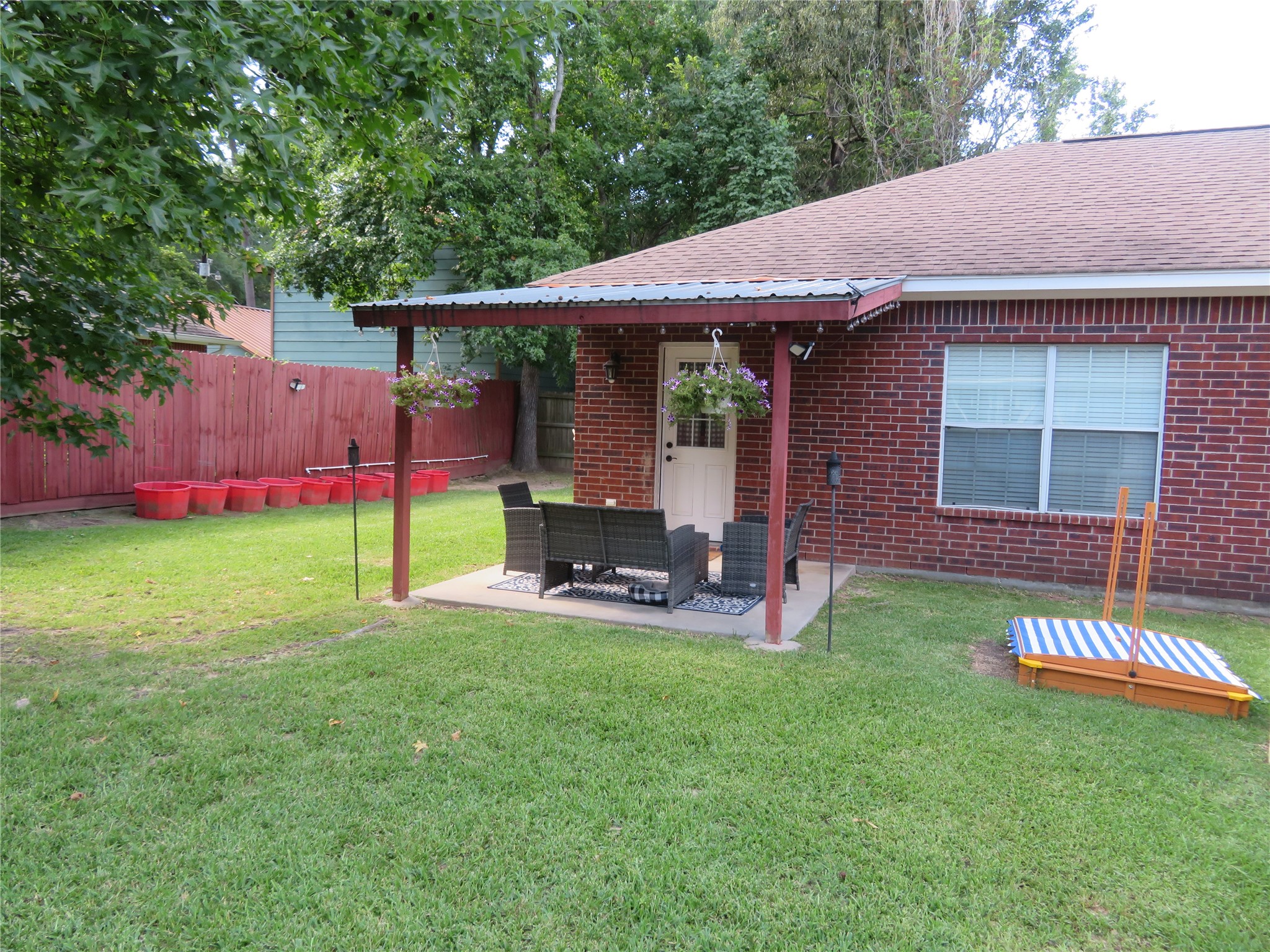 422 East Hunting Tower Run Conroe, TX 77316 - Photo 19 of 20 a view of a house with backyard porch and sitting area