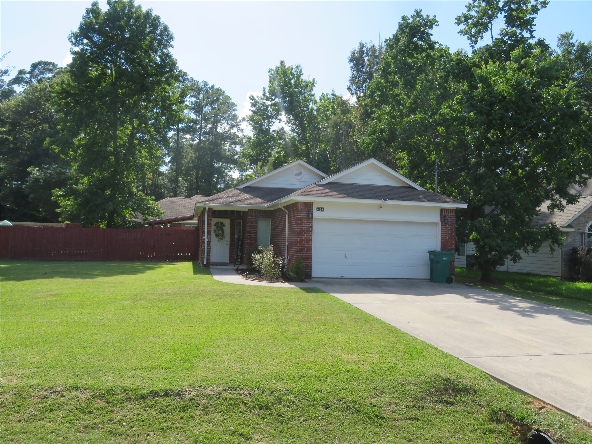 422 East Hunting Tower Run Conroe, TX 77316 - Photo 2 of 20 a front view of a house with yard and green space