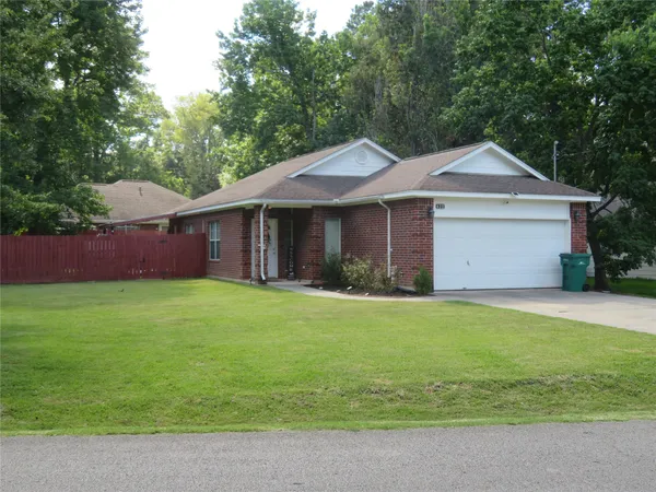 a front view of a house with a garden and yard