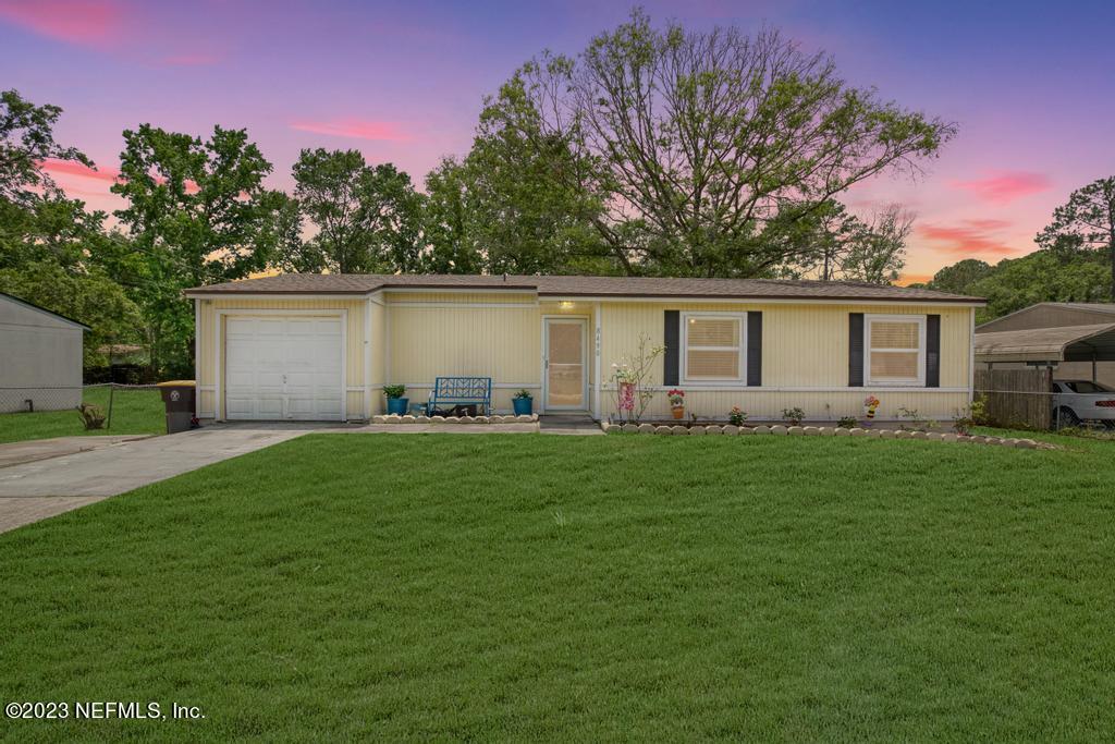 a backyard of a house with table and chairs