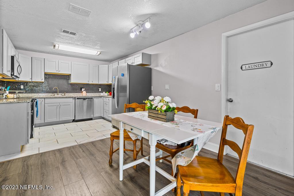 8490 Walden Road Jacksonville, FL 32244 - Photo 11 of 34 a view of a dining room with furniture and wooden floor