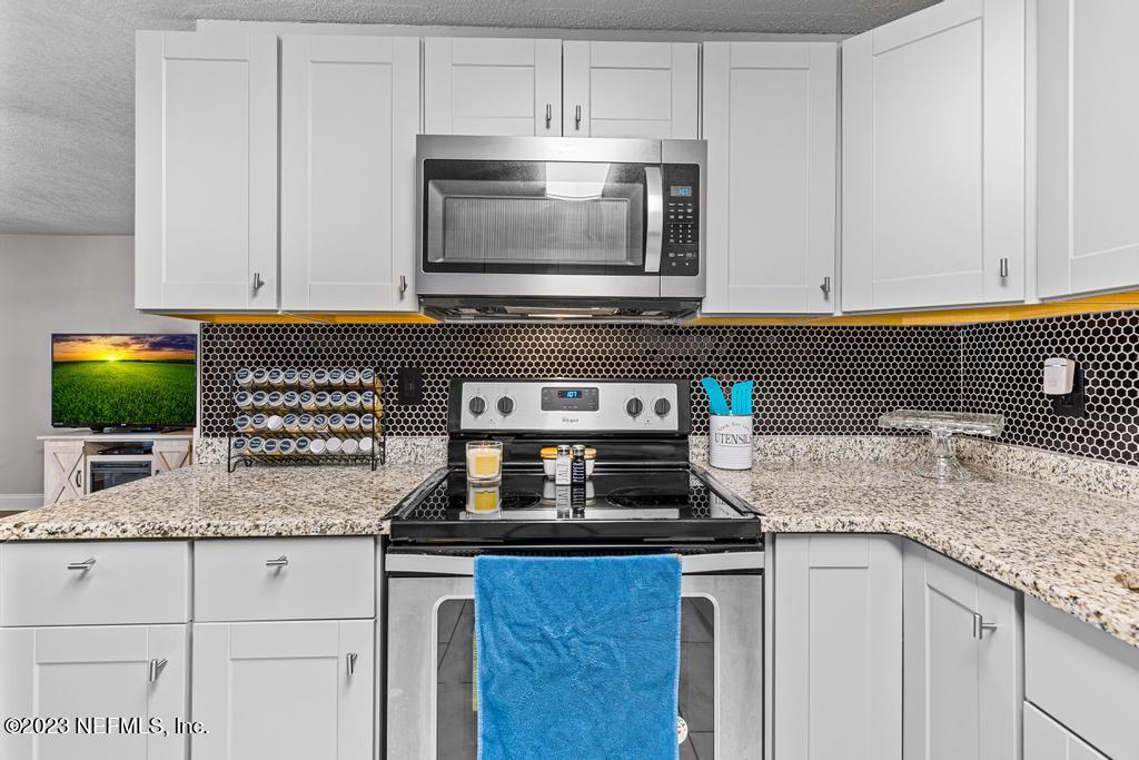 8490 Walden Road Jacksonville, FL 32244 - Photo 12 of 34 a kitchen with granite countertop a sink and a stove