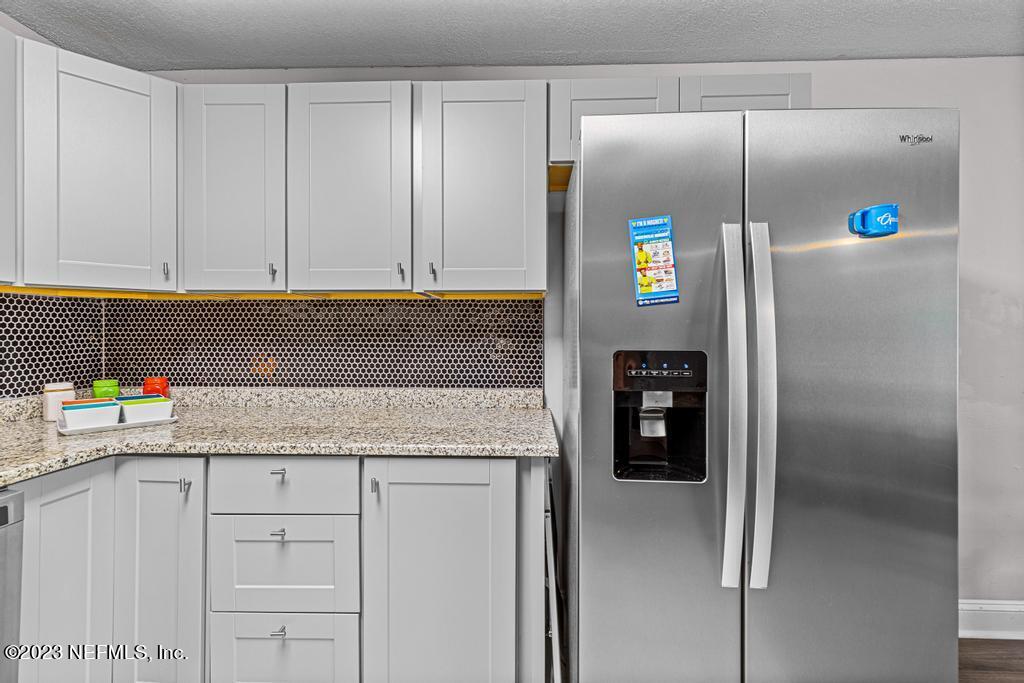8490 Walden Road Jacksonville, FL 32244 - Photo 15 of 34 a kitchen with stainless steel appliances granite countertop a refrigerator and a sink