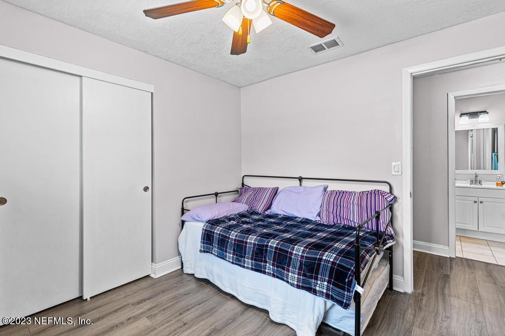 8490 Walden Road Jacksonville, FL 32244 - Photo 19 of 34 a bed sitting in a bedroom next to a bathroom
