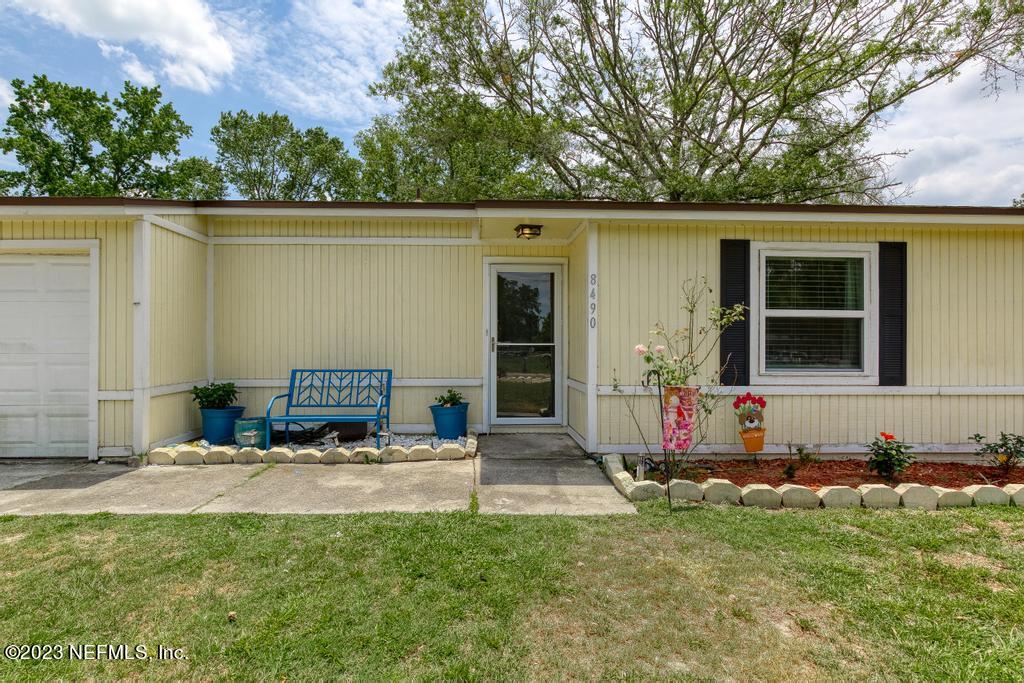 8490 Walden Road Jacksonville, FL 32244 - Photo 2 of 34 a view of house with backyard outdoor seating and green space