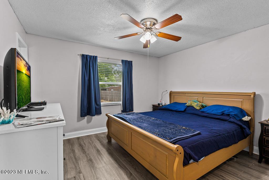 8490 Walden Road Jacksonville, FL 32244 - Photo 21 of 34 a bed sitting in a bedroom next to a window