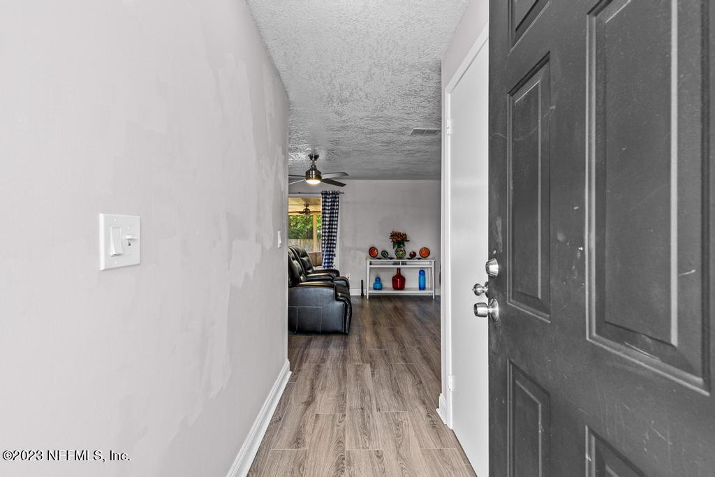 8490 Walden Road Jacksonville, FL 32244 - Photo 3 of 34 a view of a livingroom with wooden floor and furniture