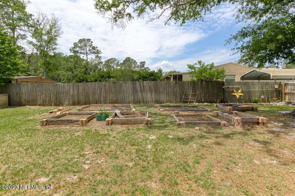 8490 Walden Road Jacksonville, FL 32244 - Photo 31 of 34 a view of swimming pool with a yard