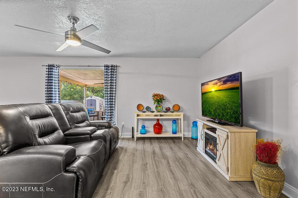 8490 Walden Road Jacksonville, FL 32244 - Photo 4 of 34 a living room with furniture and a flat screen tv