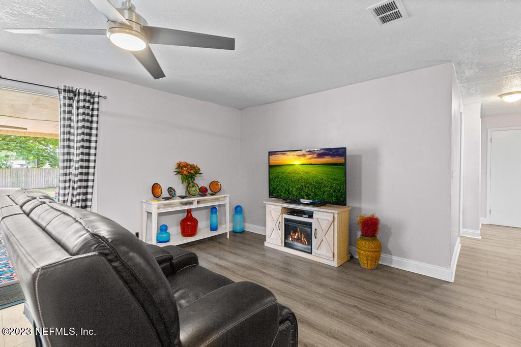 8490 Walden Road Jacksonville, FL 32244 - Photo 5 of 34 a living room with furniture and a flat screen tv