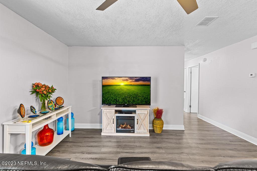 8490 Walden Road Jacksonville, FL 32244 - Photo 6 of 34 a living room with furniture and a flat screen tv