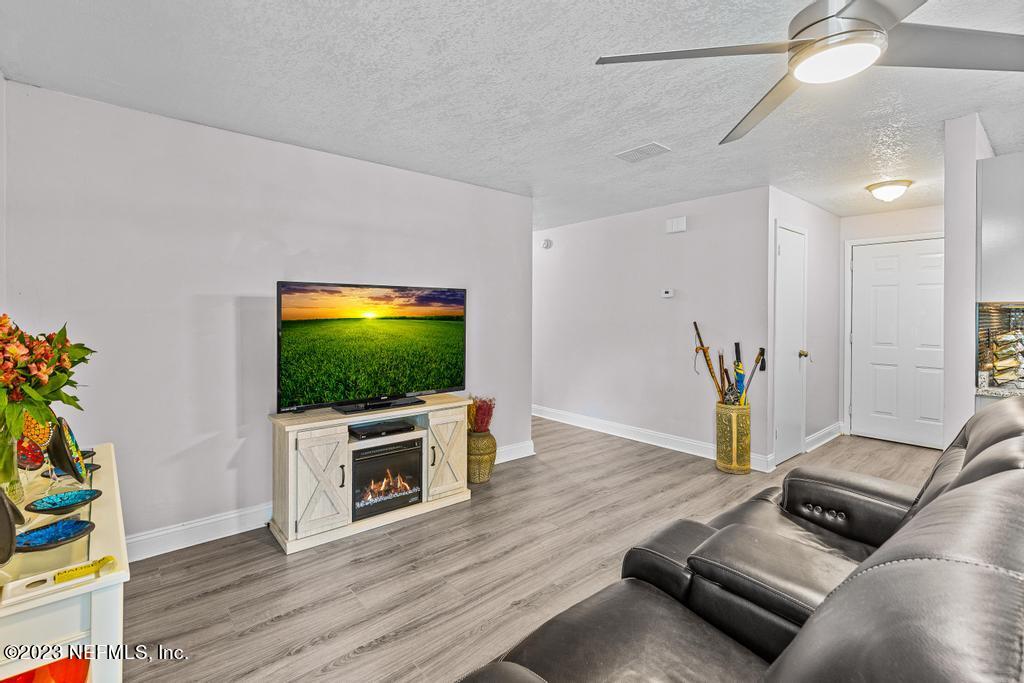 8490 Walden Road Jacksonville, FL 32244 - Photo 7 of 34 a living room with furniture and a flat screen tv
