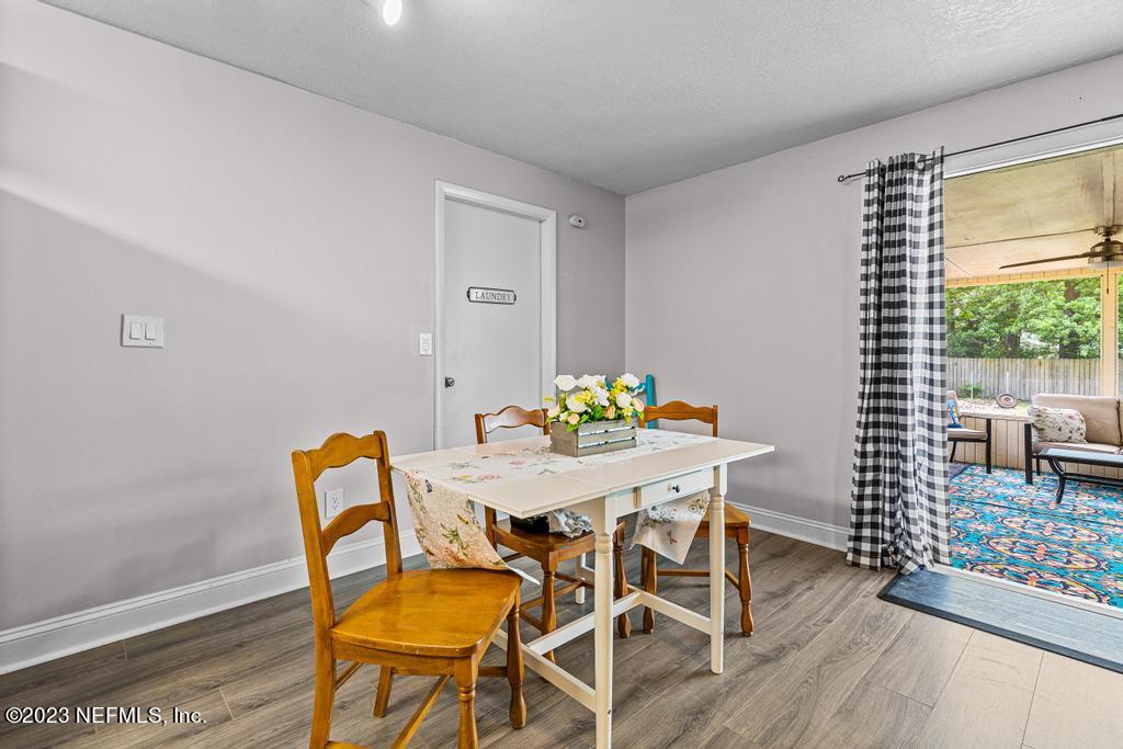 8490 Walden Road Jacksonville, FL 32244 - Photo 9 of 34 a view of a dining room with furniture and wooden floor