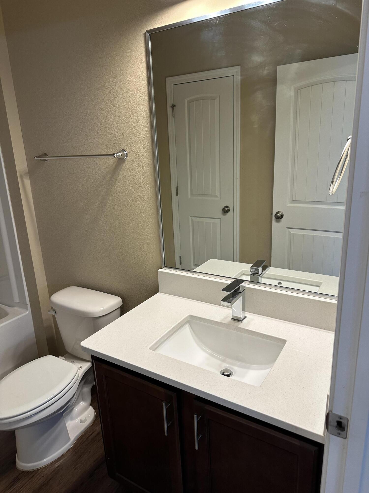 260 Cornelia Street Freeport, FL 32439 - Photo 15 of 31 a bathroom with a sink a toilet and mirror