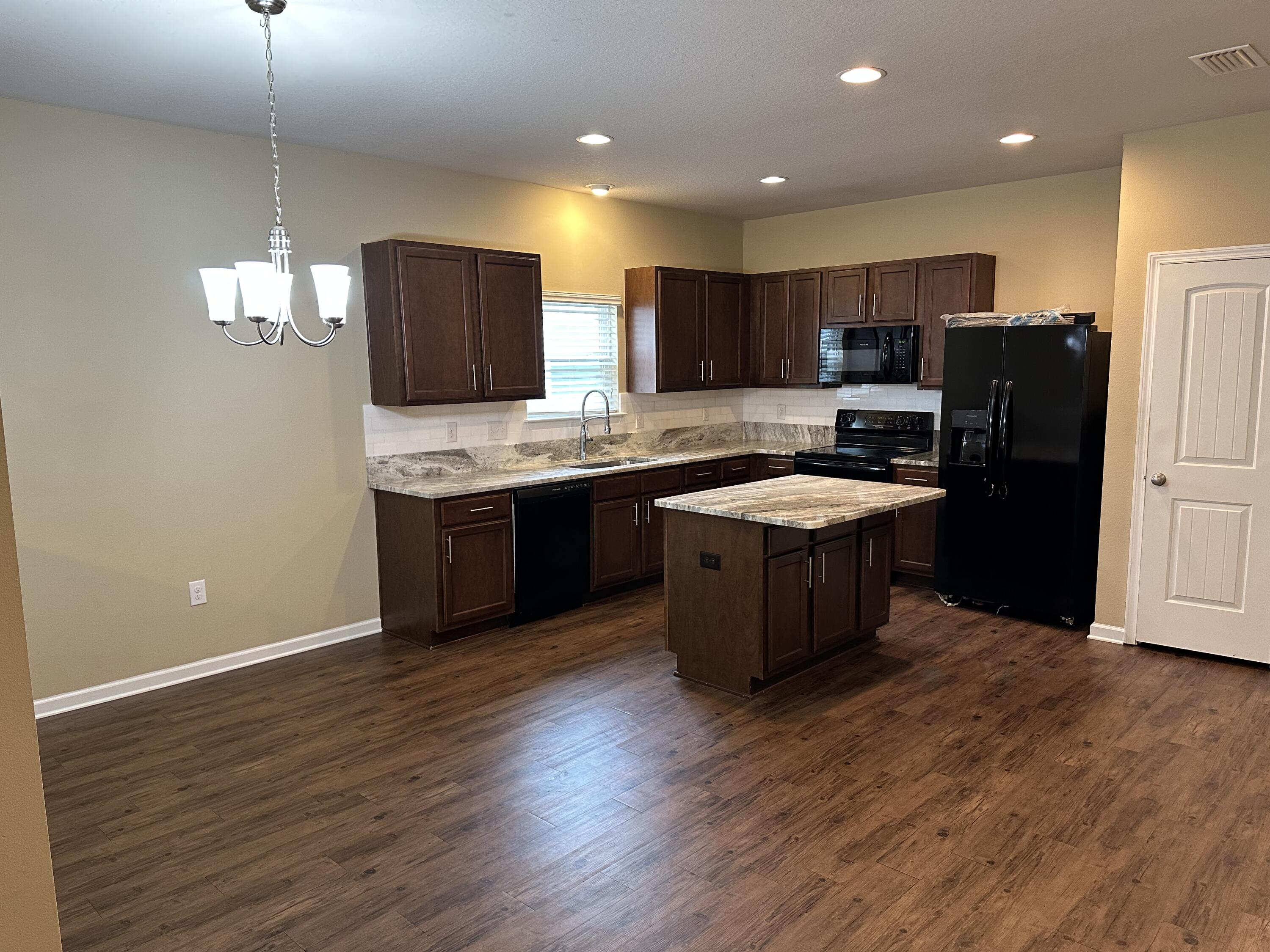 260 Cornelia Street Freeport, FL 32439 - Photo 2 of 31 a kitchen with stainless steel appliances granite countertop a stove a sink and a refrigerator