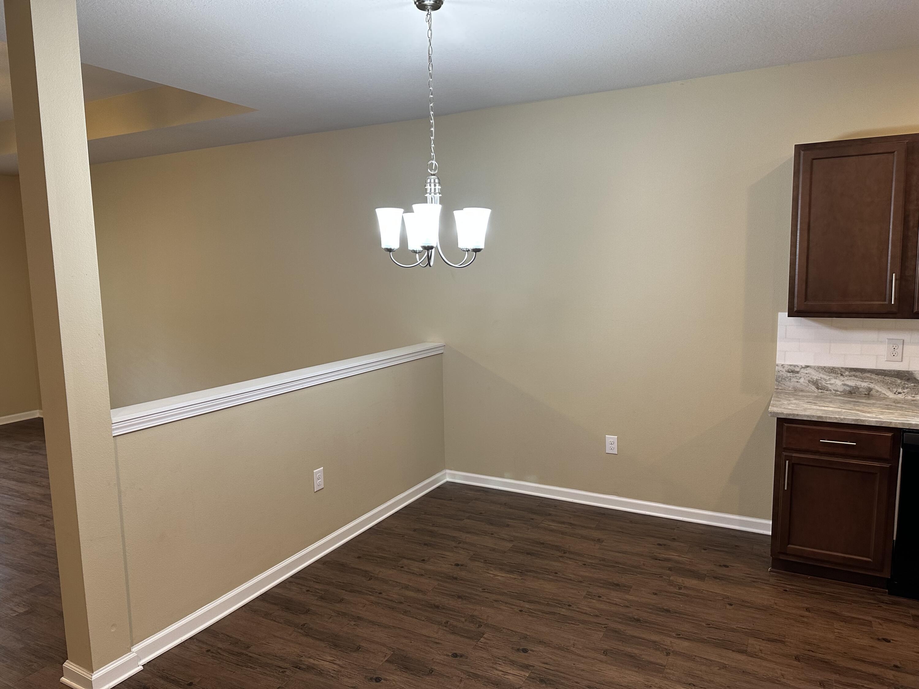 260 Cornelia Street Freeport, FL 32439 - Photo 5 of 31 a view of a kitchen with wooden floor and a ceiling fan