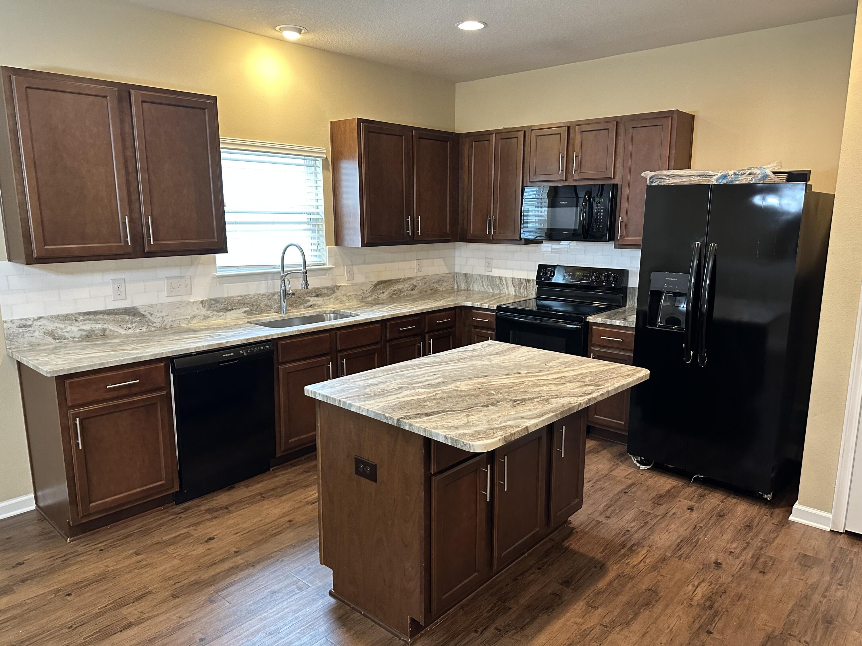 260 Cornelia Street Freeport, FL 32439 - Photo 8 of 31 a kitchen with a sink a stove a refrigerator and cabinets