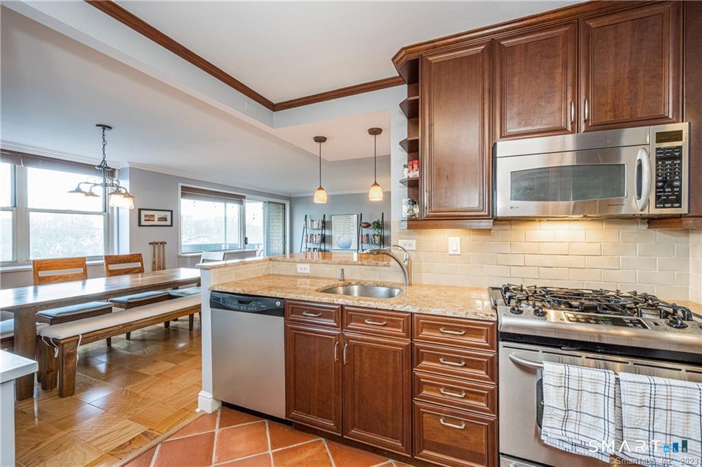 50 Glenbrook Road, Unit 6E Stamford, CT 06902 - Photo 9 of 18 a kitchen with stainless steel appliances granite countertop a sink stove and refrigerator