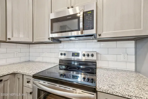 a kitchen with a stove and a microwave