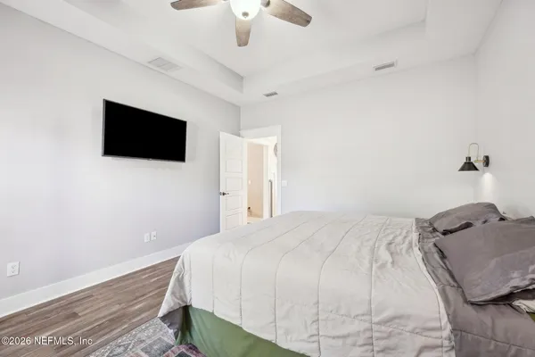 a bedroom with a bed and a flat screen tv