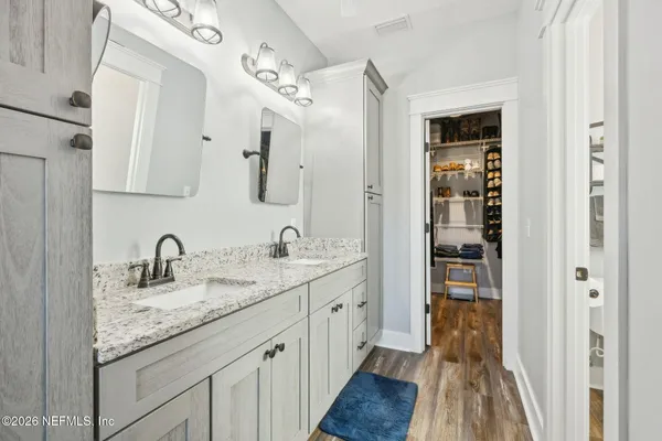 a bathroom with double sink and a mirror