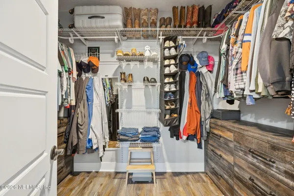 a bedroom with furniture and a flat screen tv
