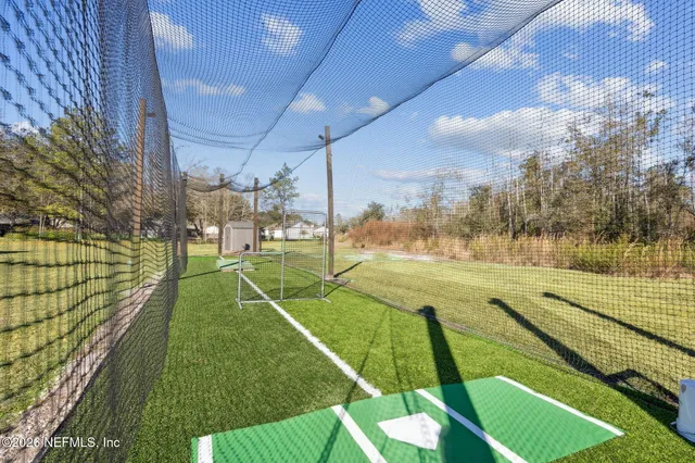 a view of a park with iron fence