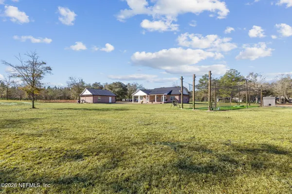 a view of a house with a backyard and a garden