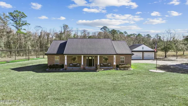 an aerial view of a house with a yard