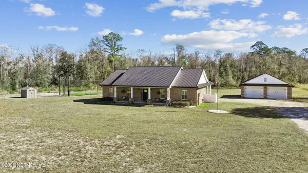 a aerial view of a house with large trees