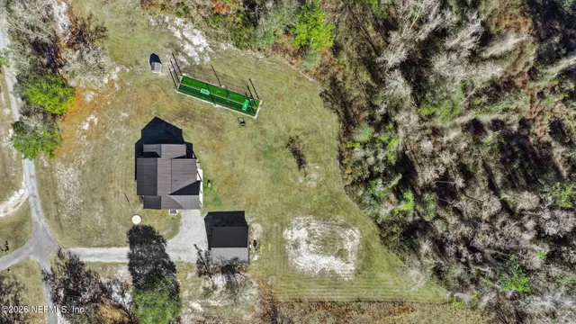 a backyard of a house with table and chairs