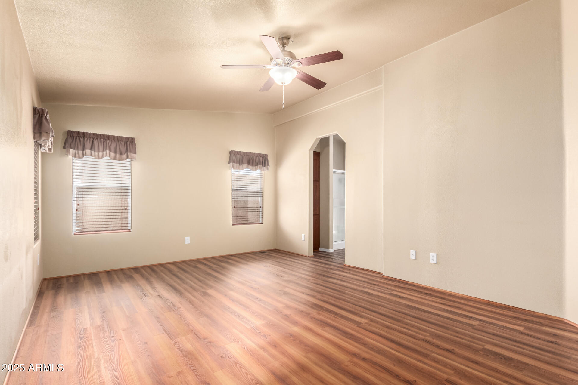 2929 East Main Street, Unit 159 Mesa, AZ 85213 - Photo 14 of 30 an empty room with wooden floor and windows