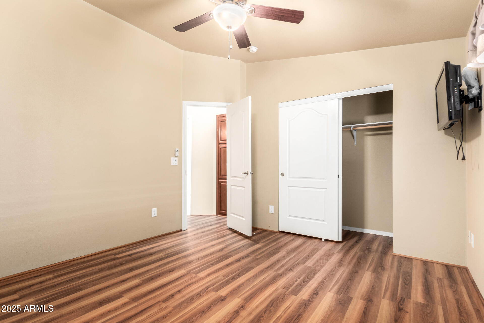 2929 East Main Street, Unit 159 Mesa, AZ 85213 - Photo 19 of 30 a view of empty room with wooden floor and fan