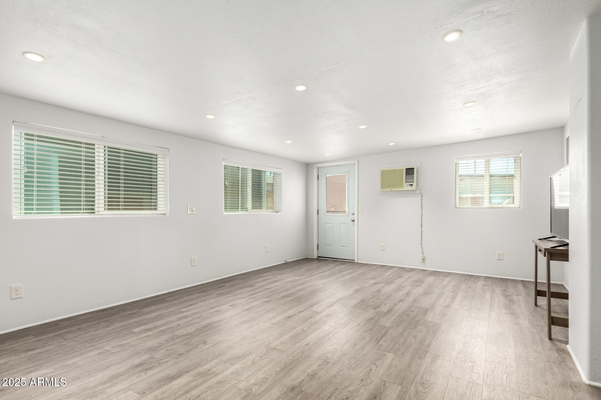 2929 East Main Street, Unit 159 Mesa, AZ 85213 - Photo 22 of 30 a view of an empty room with wooden floor and a window