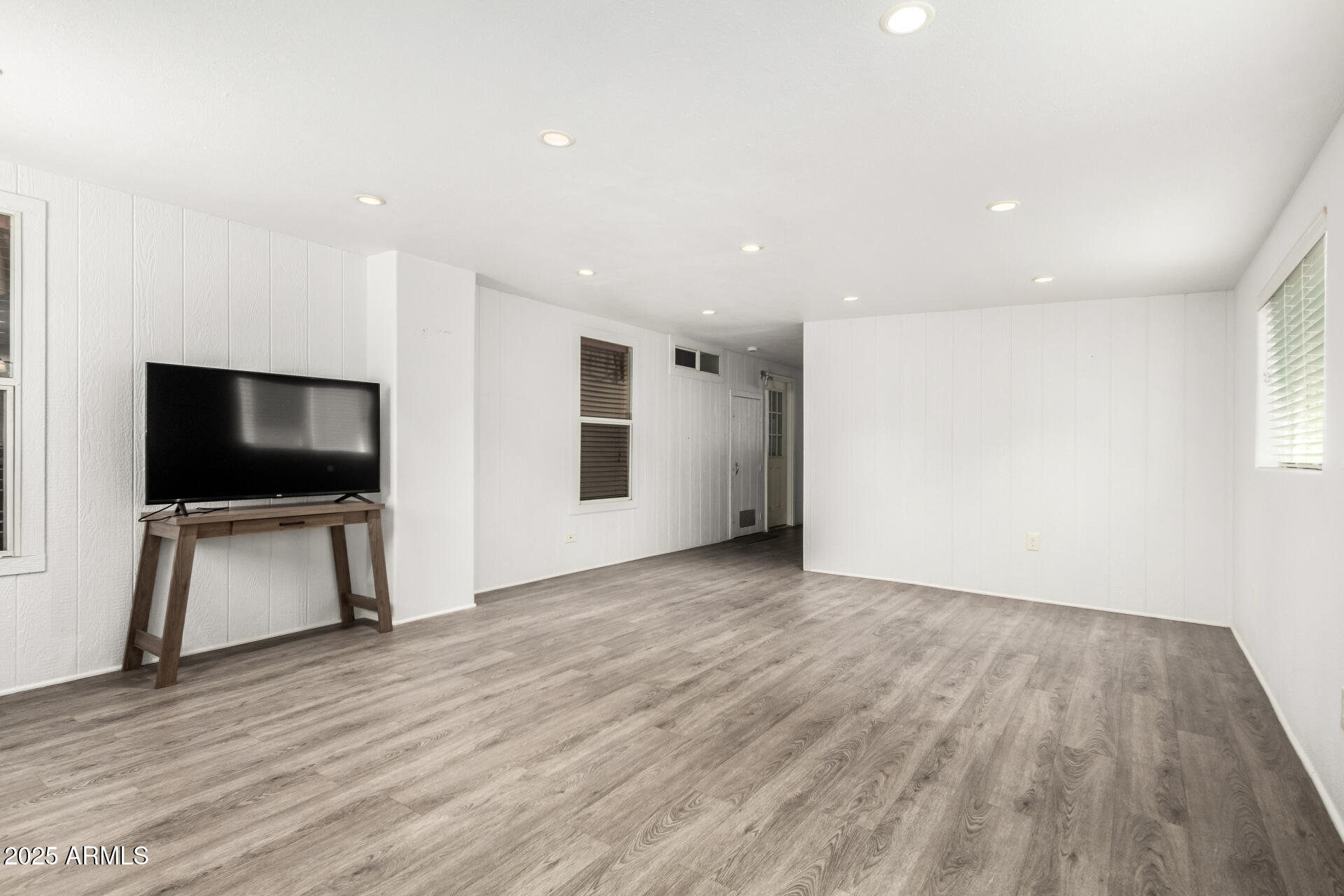2929 East Main Street, Unit 159 Mesa, AZ 85213 - Photo 23 of 30 a view of a livingroom with wooden floor and a flat screen tv
