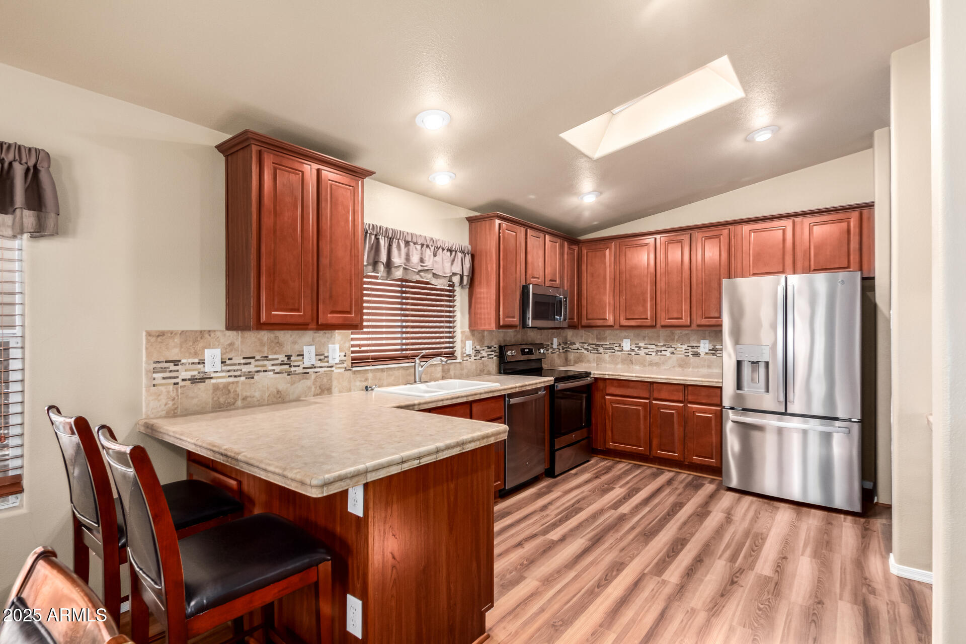 2929 East Main Street, Unit 159 Mesa, AZ 85213 - Photo 6 of 30 a kitchen with granite countertop a sink stove and refrigerator