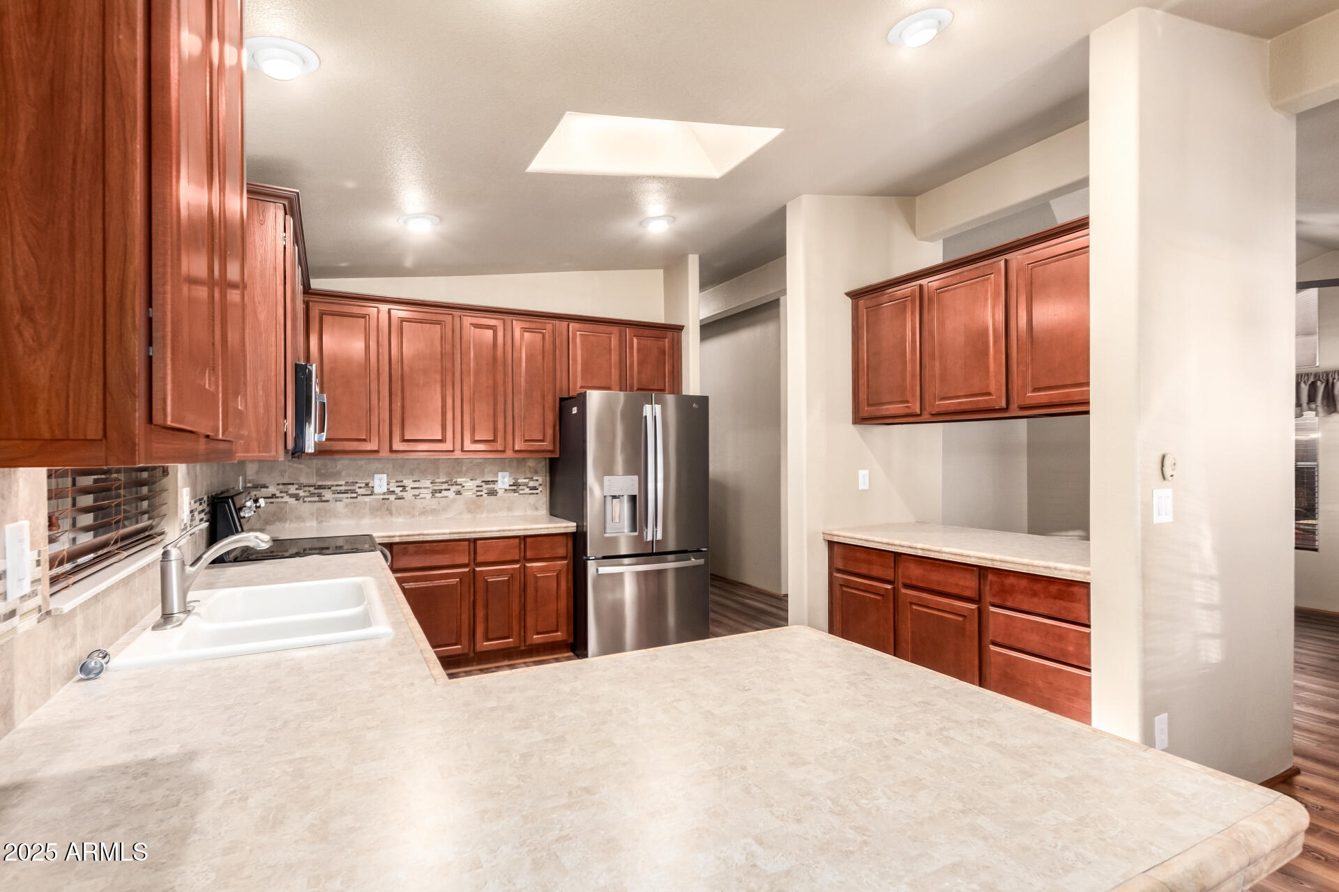 2929 East Main Street, Unit 159 Mesa, AZ 85213 - Photo 8 of 30 a kitchen with stainless steel appliances granite countertop a refrigerator and wooden cabinets