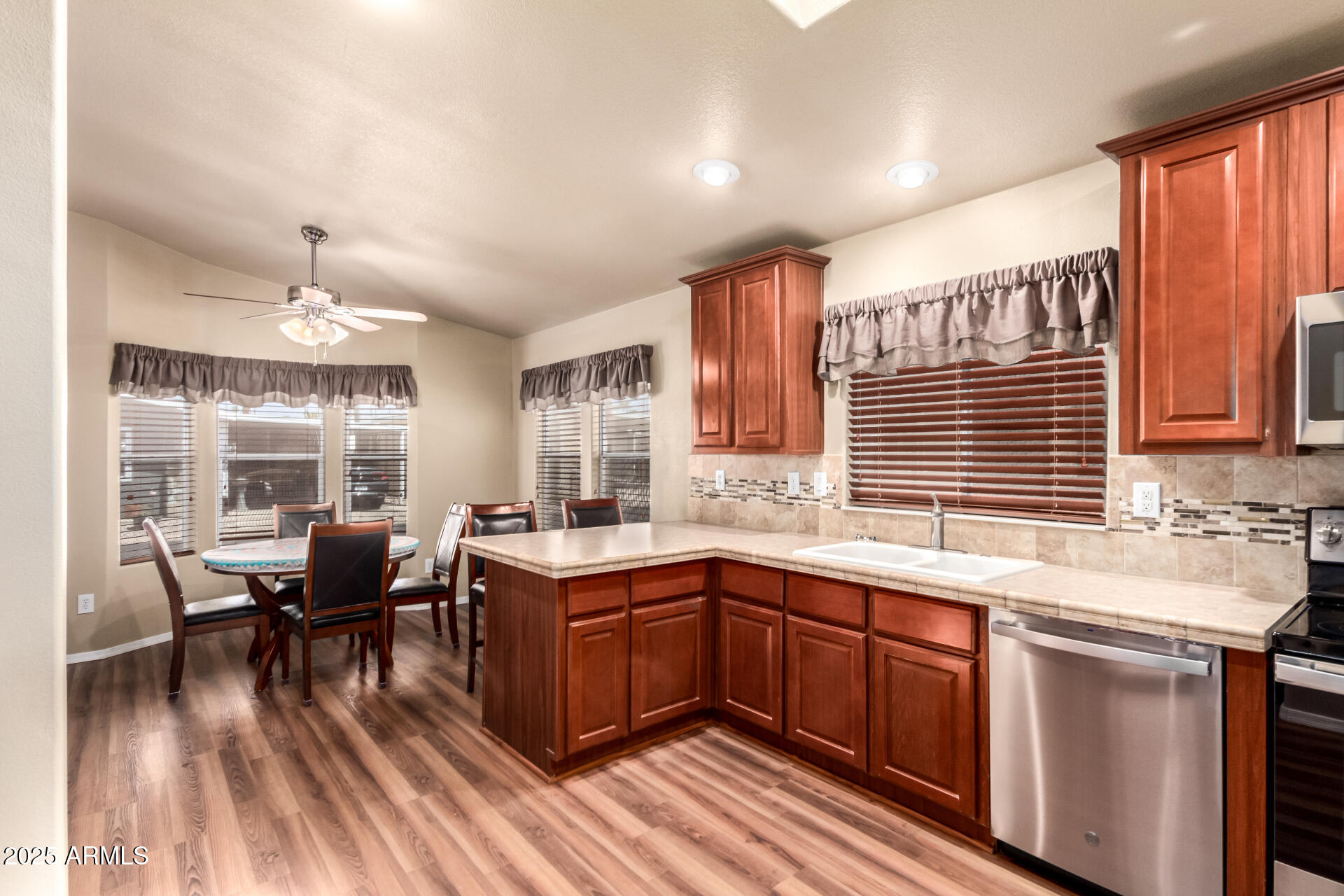 2929 East Main Street, Unit 159 Mesa, AZ 85213 - Photo 9 of 30 a kitchen with lots of counter top space and dining table