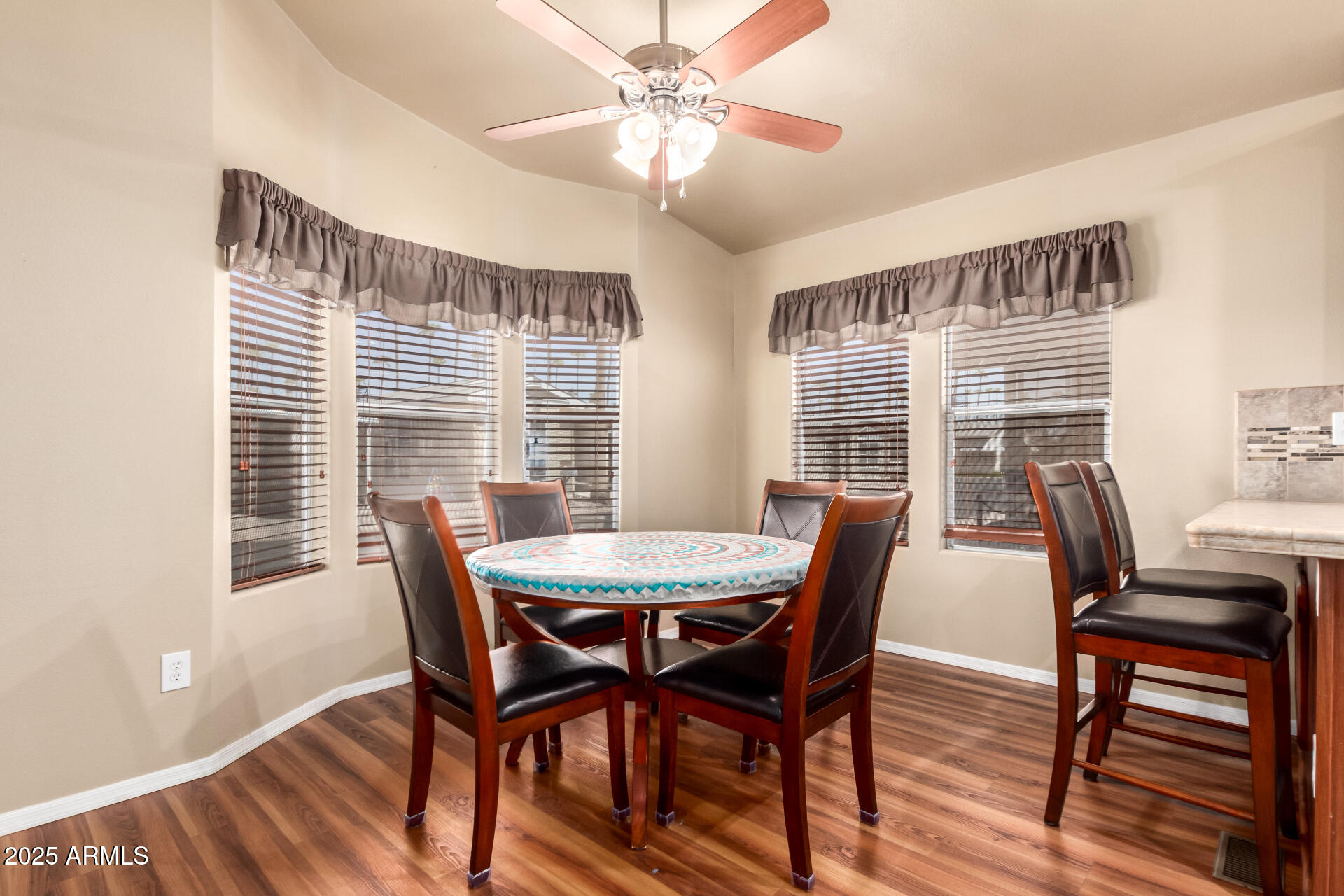2929 East Main Street, Unit 159 Mesa, AZ 85213 - Photo 10 of 30 a view of a dining room with furniture window and wooden floor