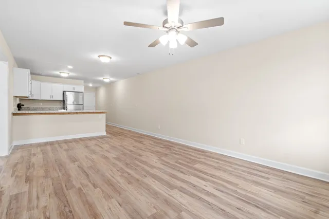 a view of kitchen with granite countertop cabinets and wooden floor