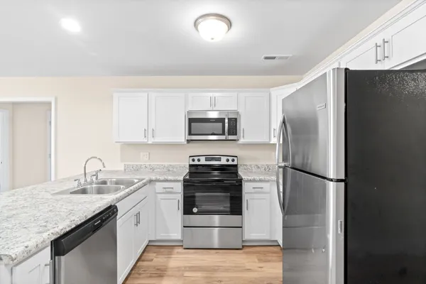 a kitchen with a refrigerator and a sink